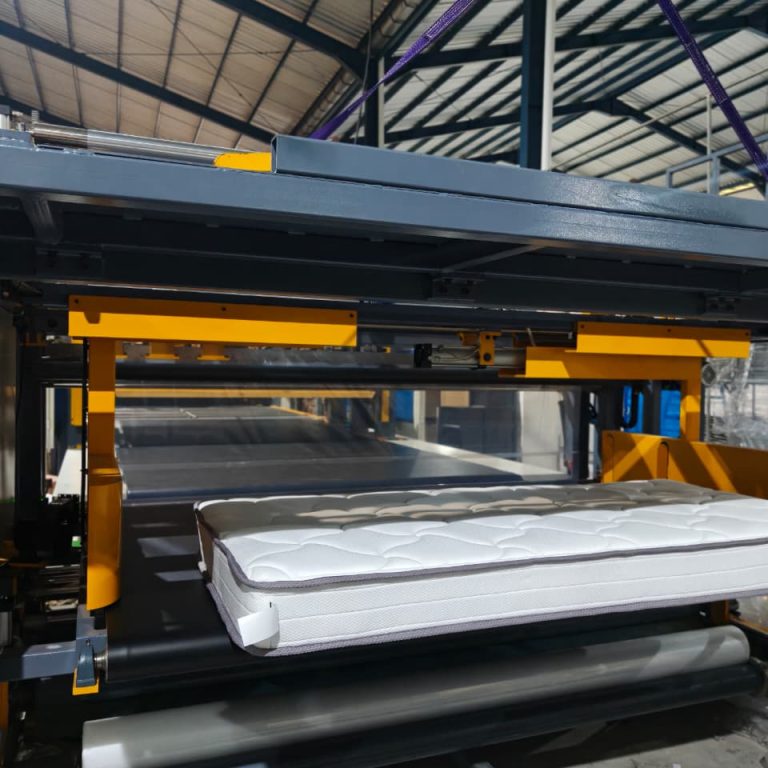 Mattress moving through final production equipment