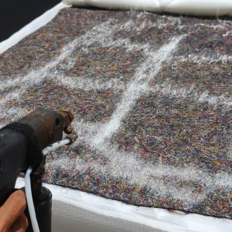 Adhesive application during mattress assembly