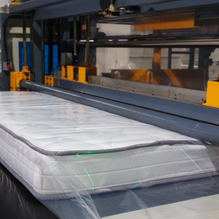 Mattress quilting panel moving through production equipment